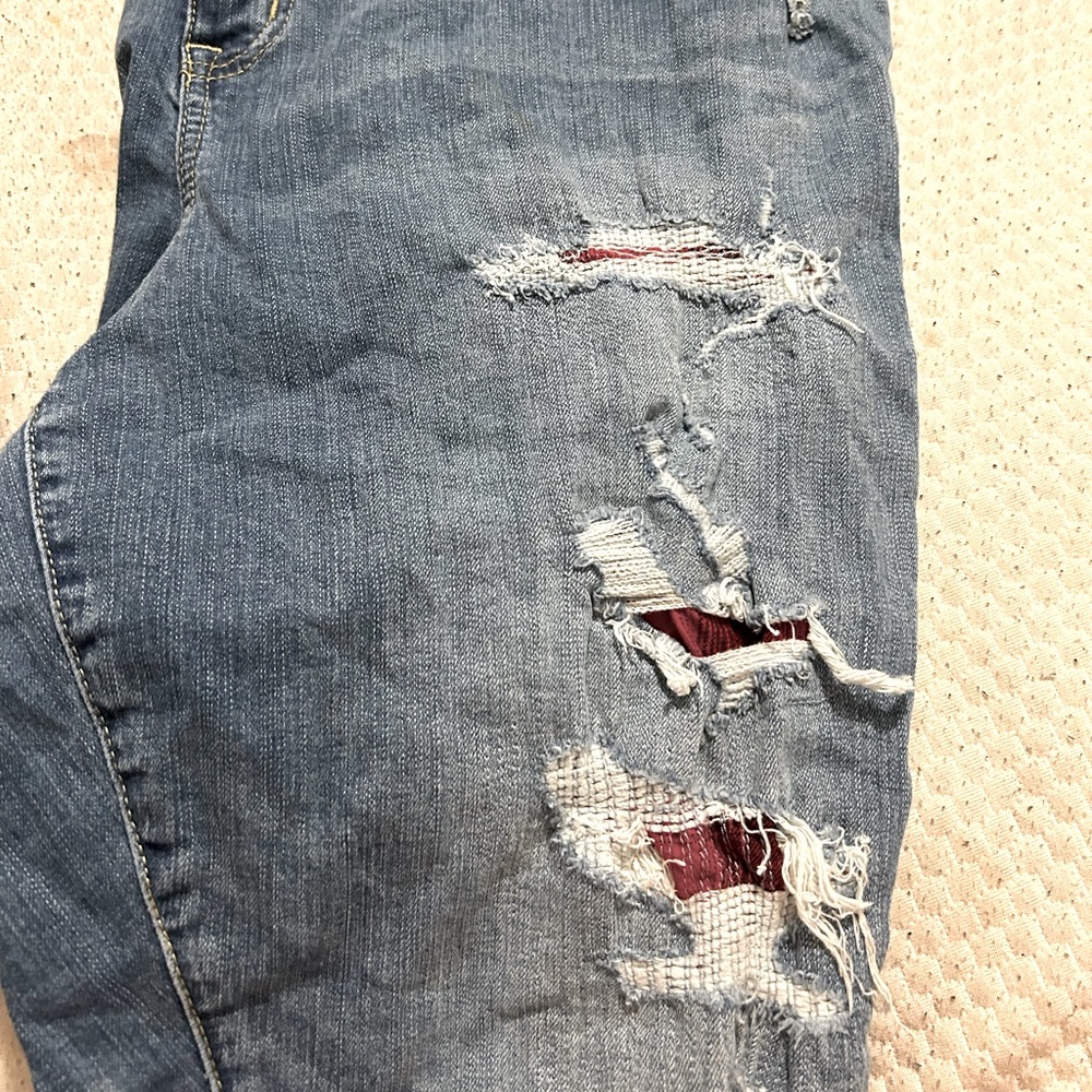 Torrid size 18 jeans, with red details in rips in jeans.